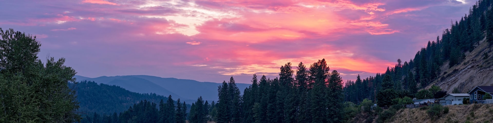 The sun sets over the Clark Fork River in the town of Superior, Montana, USA
