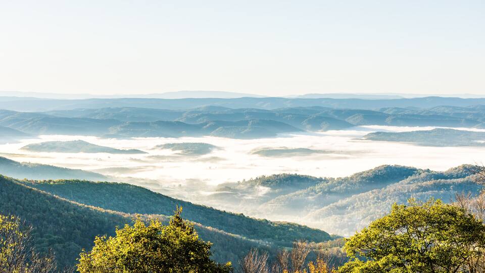 A mountainous landscape with rolling hills and a valley.