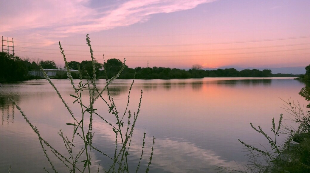 The West Twin river flows through Shoto falls to the west side of the city of Two Rivers and into Lake Michigan. This was taken at dawn as the sun is starting to set on the horizon. Th3 Golden Hour.