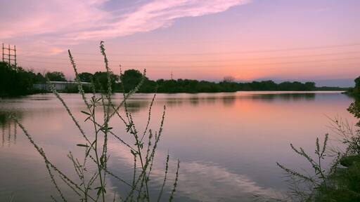 The West Twin river flows through Shoto falls to the west side of the city of Two Rivers and into Lake Michigan. This was taken at dawn as the sun is starting to set on the horizon. Th3 Golden Hour.