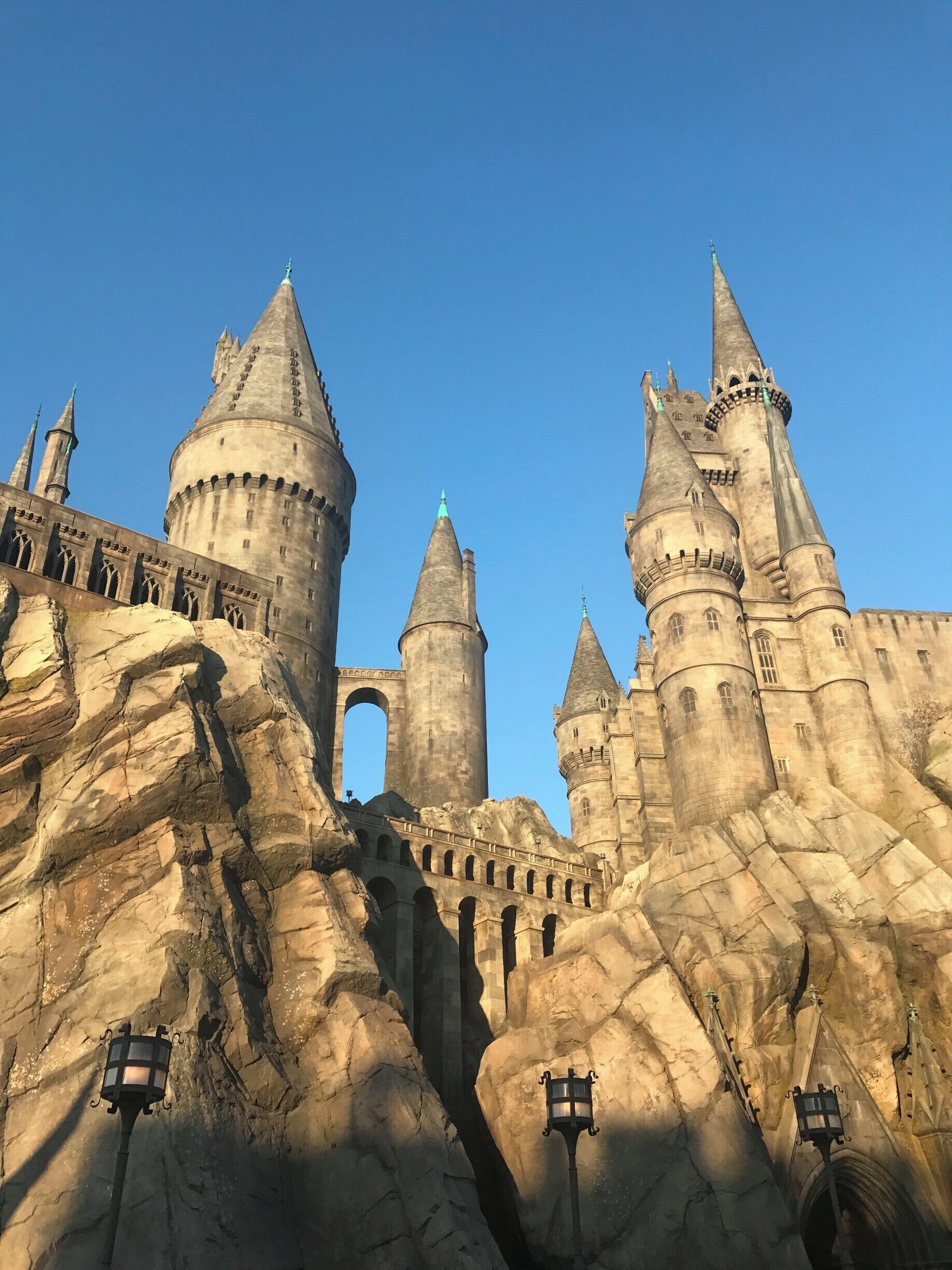 A castle with multiple towers and a large archway.