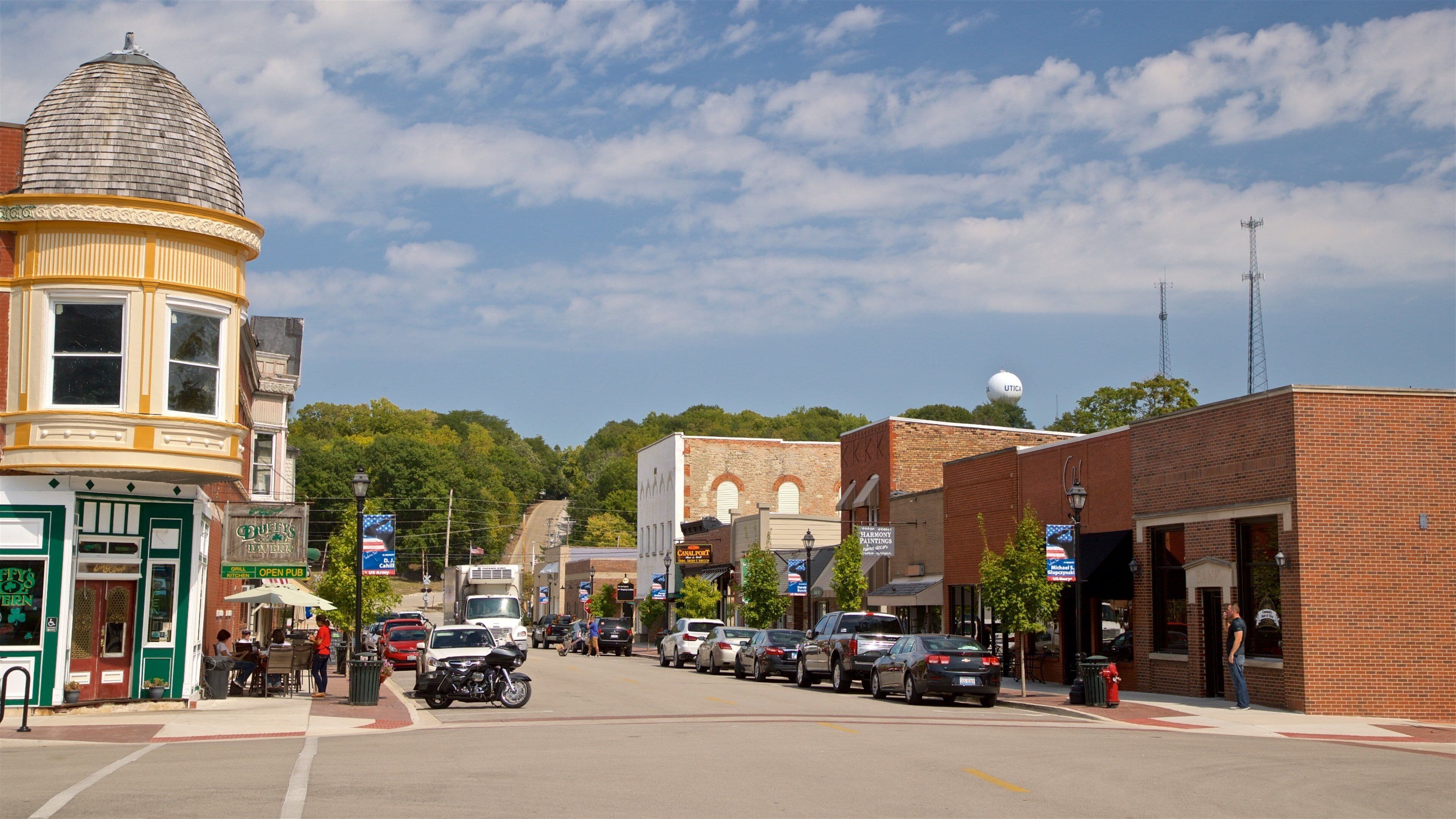A street lined with historic buildings, a diner, and parked cars.