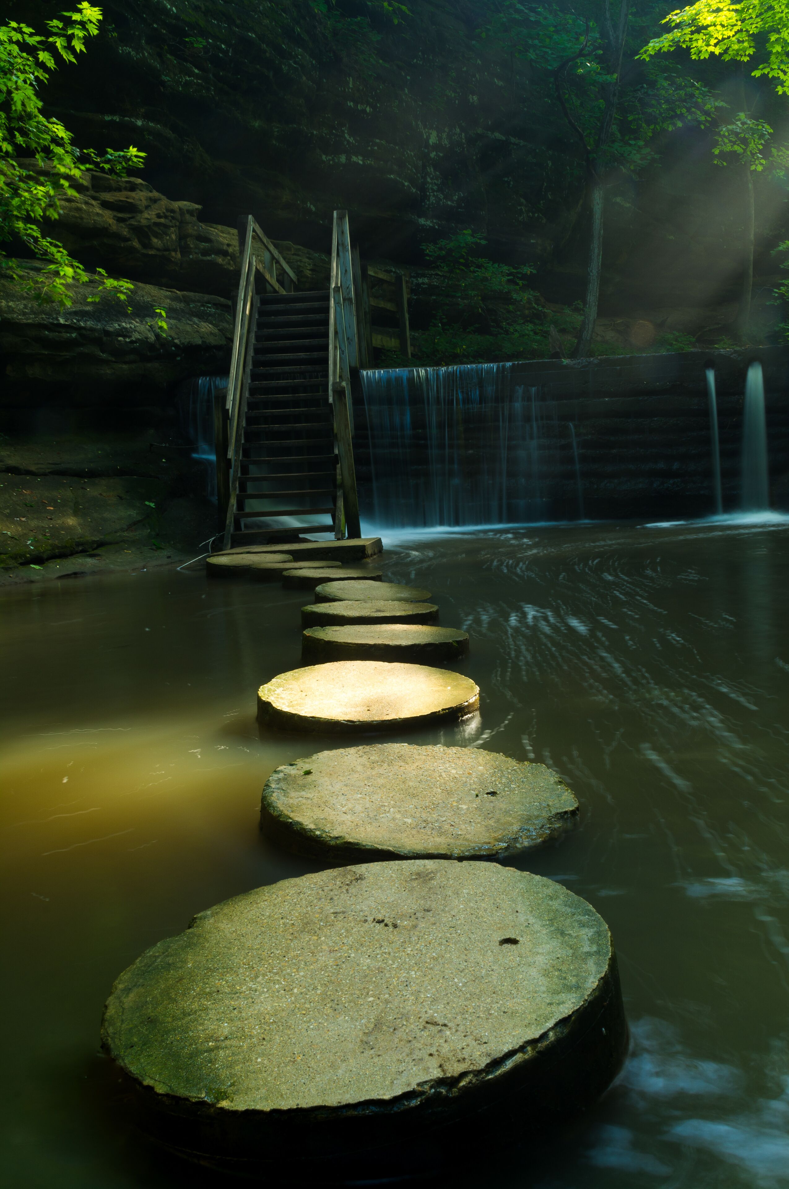 Light shining on the stepping stones in Matthiessen State Park on a Summer's morning.  Illinois, U.S.A..