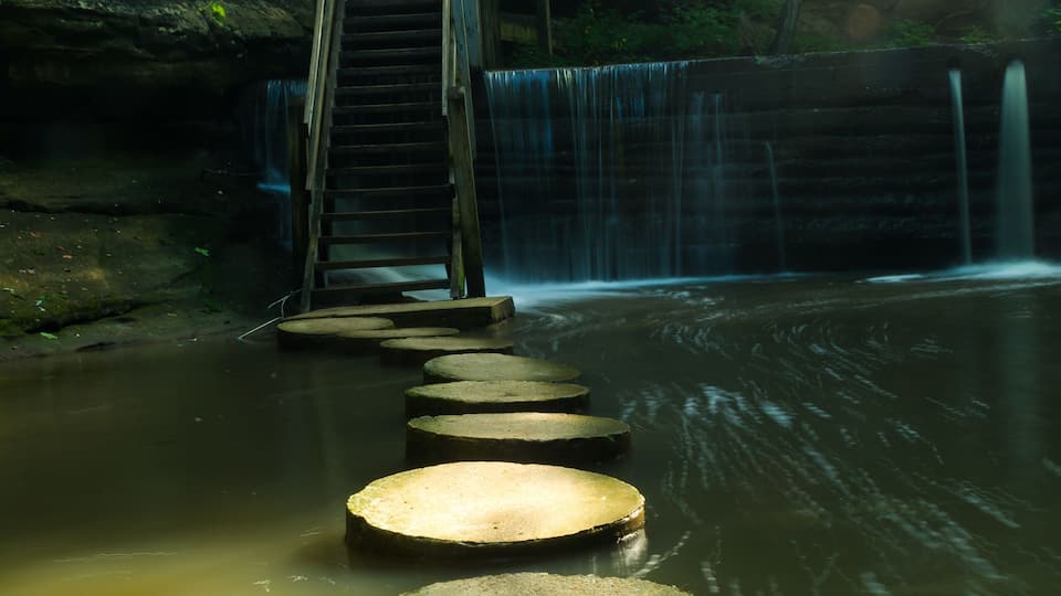 Light shining on the stepping stones in Matthiessen State Park on a Summer's morning. Illinois, U.S.A..