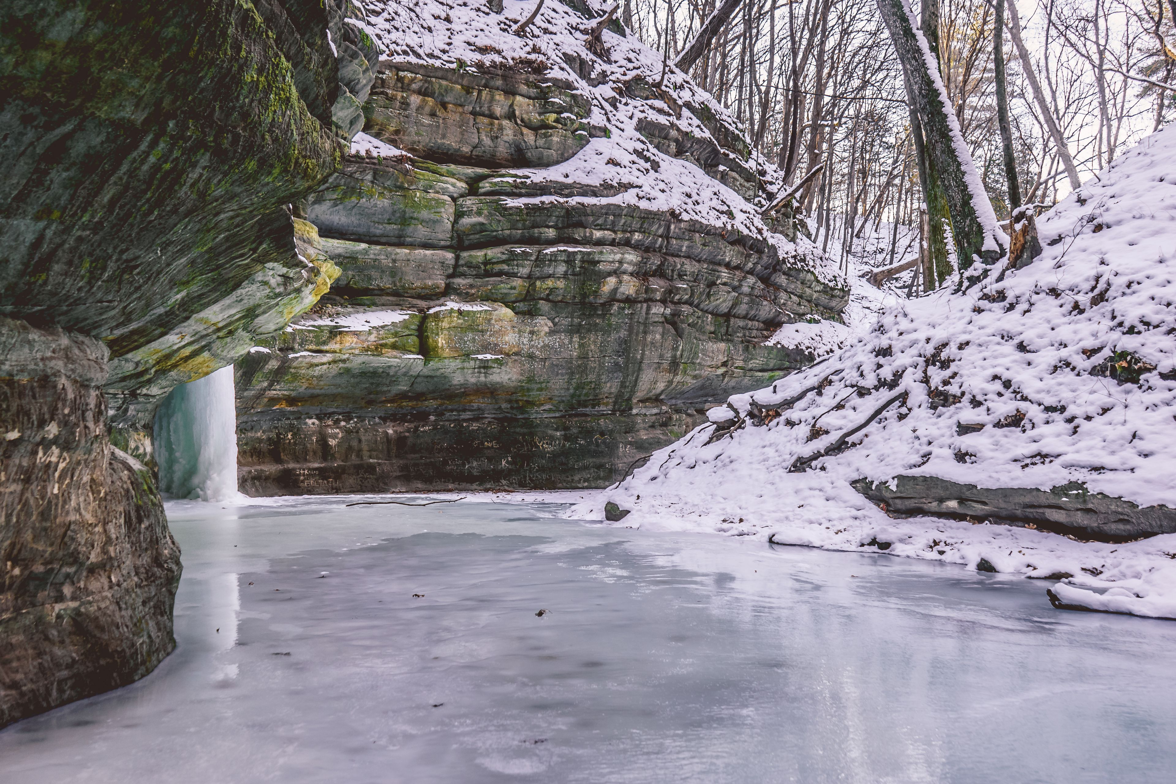 A frozen ice covered trail underneath sandstone cliffs at Starved Rock State Park near Utica, Illinois, USA.