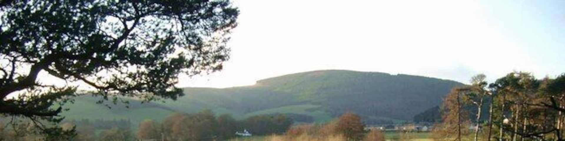 The Leithen Water meets the Tweed Just south of Innerleithen. The Leithen Water is flowing in from the right. Both rivers are very high after two weeks of almost continuous rain.