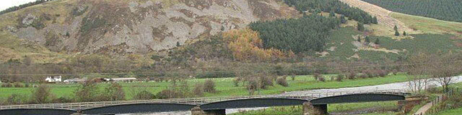 National Cycle Network route 1 An off road section using the old railway bridge to cross the Tweed at Innerleithen. Pirn Craig in the background.