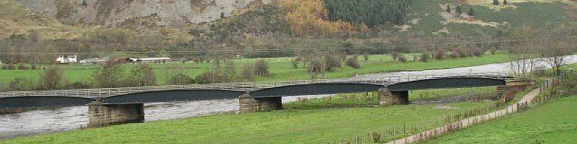 National Cycle Network route 1 An off road section using the old railway bridge to cross the Tweed at Innerleithen. Pirn Craig in the background.