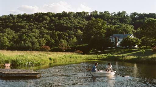Mother and daughter in rowing boat, on water