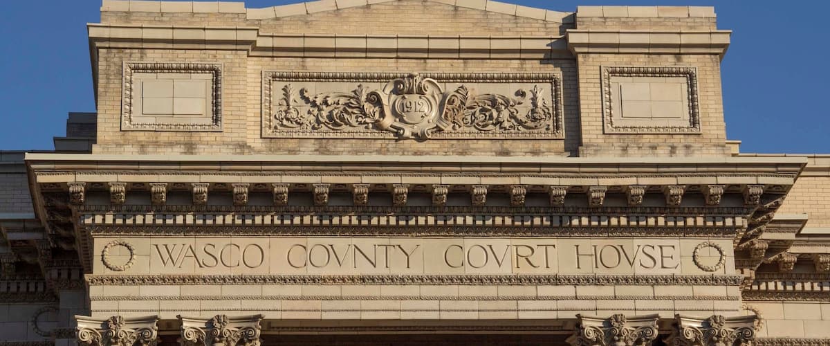 The facade of the Wasco County Courthouse with ornate carvings and columns.