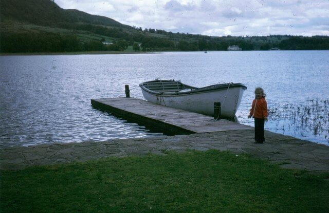 A lake with a dock and a boat.