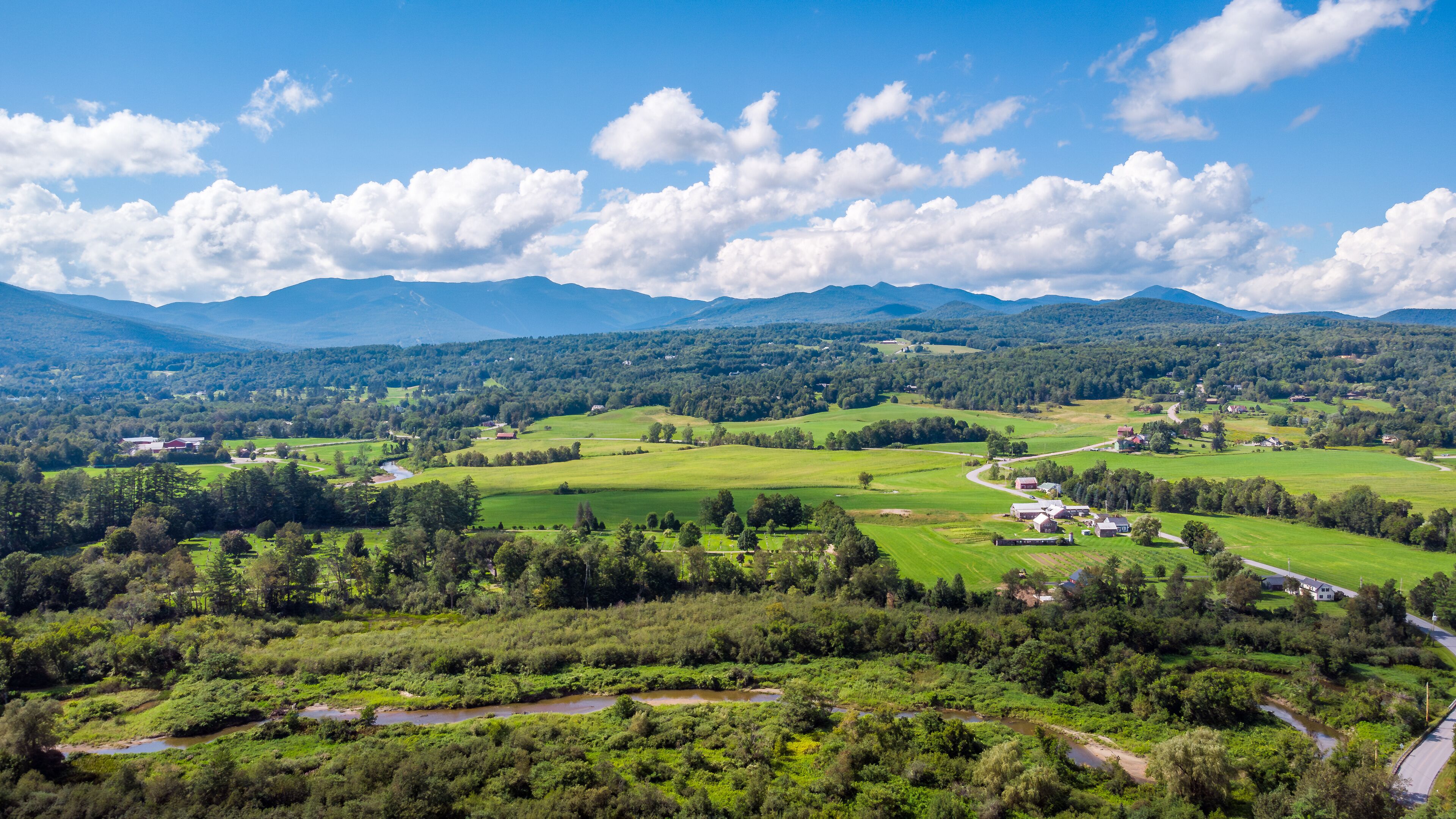 Aerial view of Stowe, farms, fields and Mount Mansfield, the Green Mountains, Vermont, New England, United States. Photo taken by drone in August 2023.