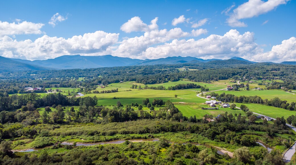 Aerial view of Stowe, farms, fields and Mount Mansfield, the Green Mountains, Vermont, New England, United States. Photo taken by drone in August 2023.