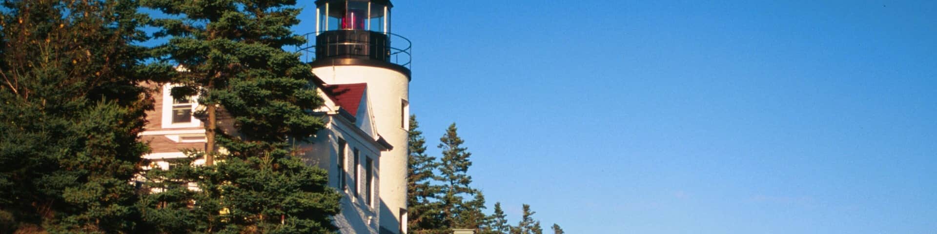 Bar Harbor showing rugged coastline and a lighthouse