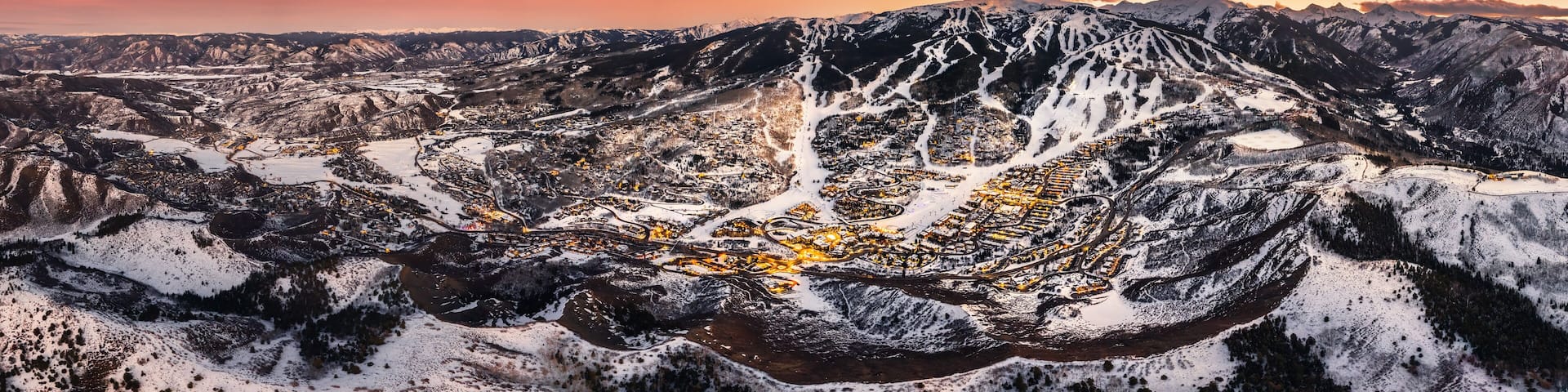Snowmass Village with sunset and ski slopes