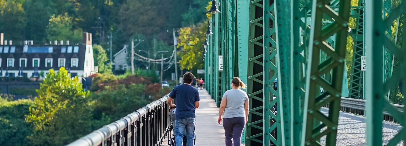 Family walking across the Stockton Bridge in NJ