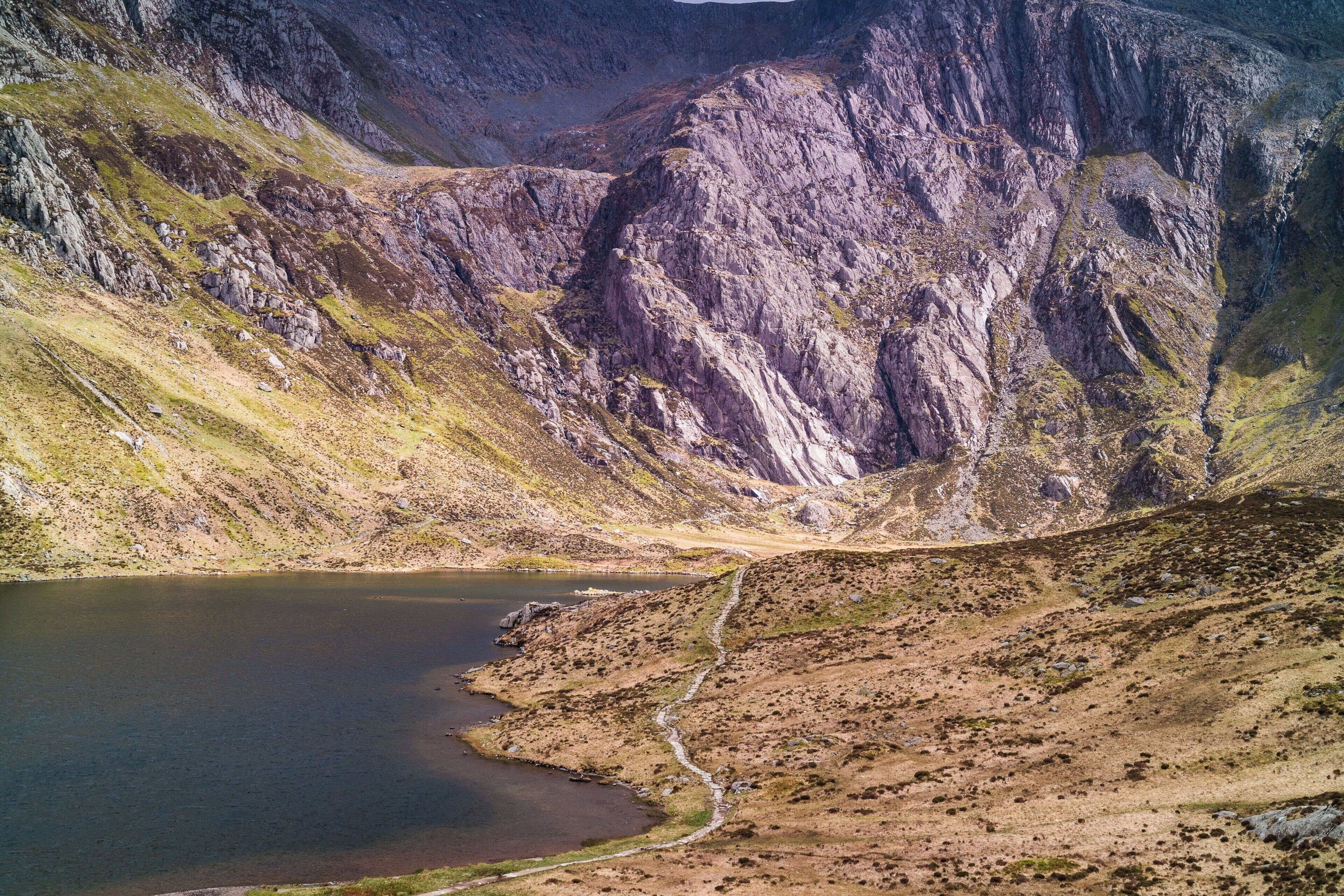 Tucked behind the hill across the road from llyn Ogwen is a smaller but more scenic Lake (Llyn)  Catch the sun at different times of day and year to see the effect it has on the surrounding Rocks and Craggs.  A reasonably accessible path goes around Llyn Idwal