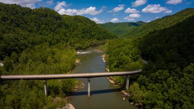 MAY 8, 2023, ANSTED WEST VIRGINIA, USA - Route 16 goes over New River in West Virginia surrounded by green forest in spring