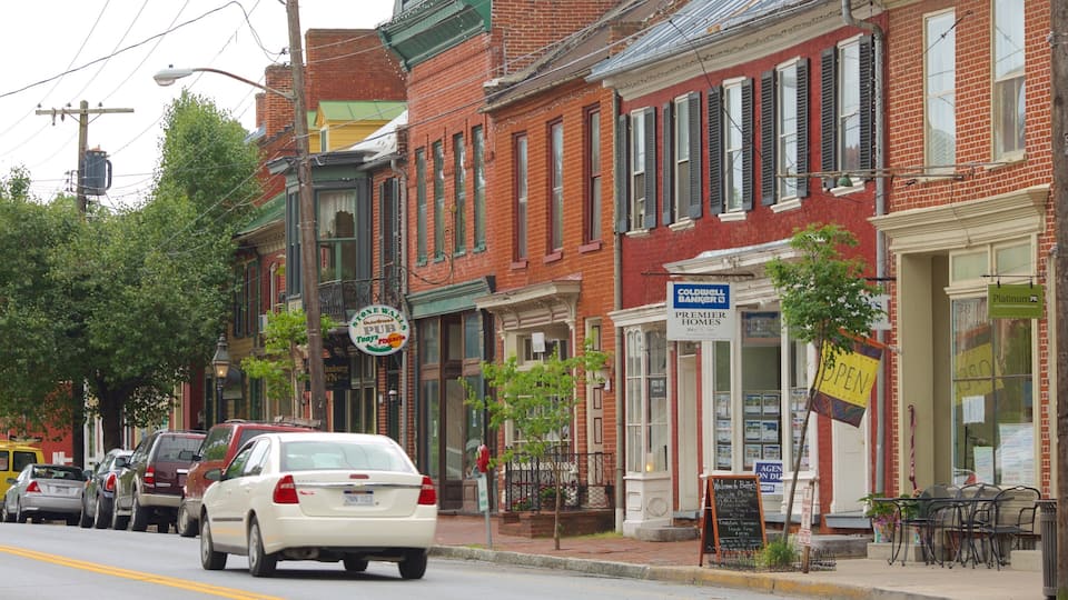 A street lined with brick buildings, including a bank and a restaurant.