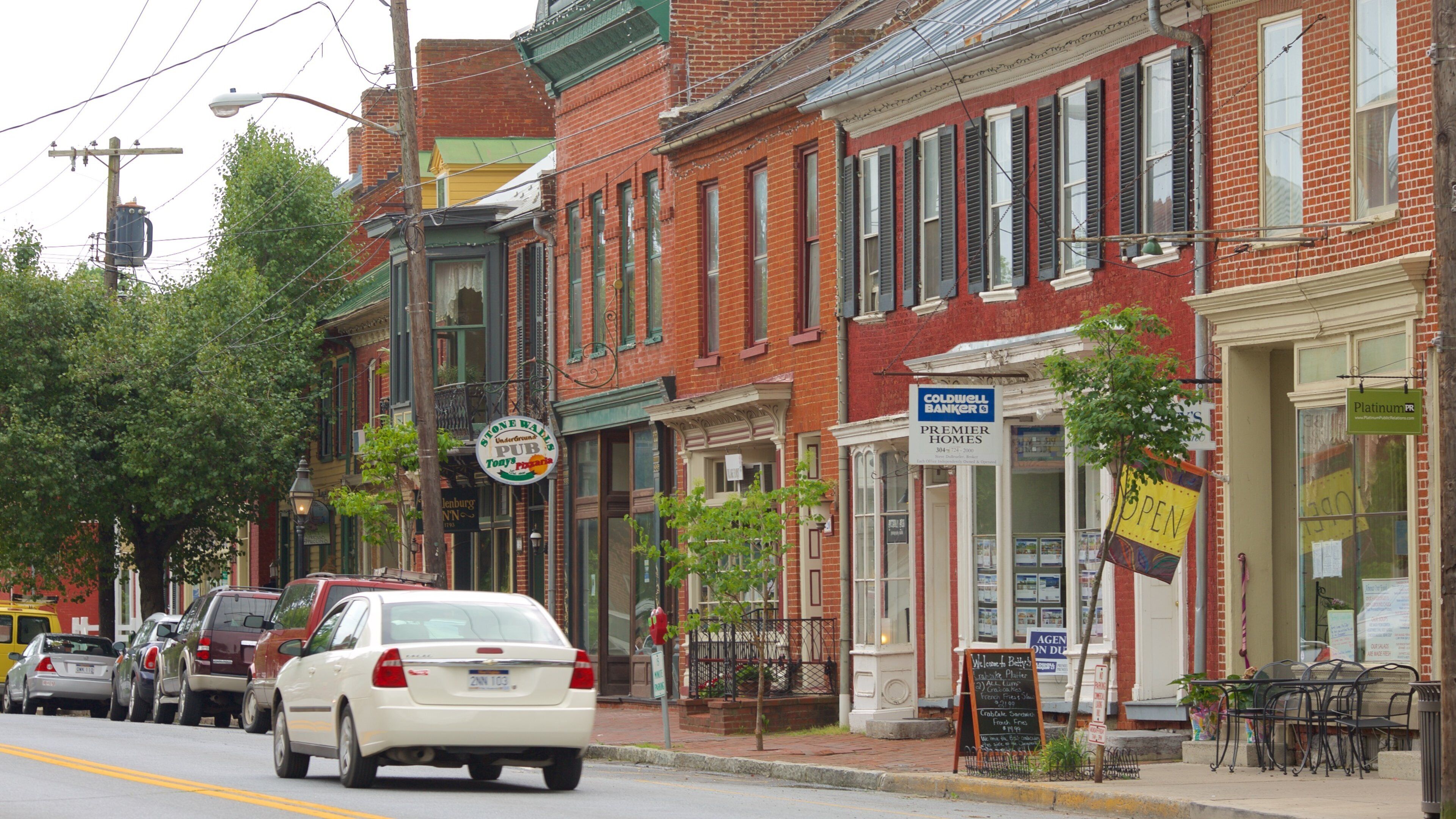 A street lined with brick buildings, including a bank and a restaurant.