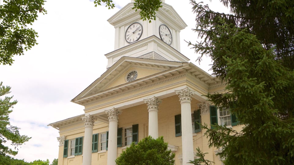 A historic building with a clock tower, columns, and a classic architectural style.