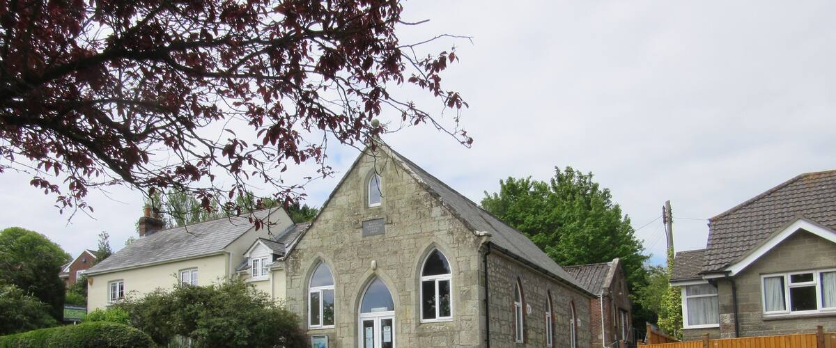 A stone church with arched windows and a traditional design.