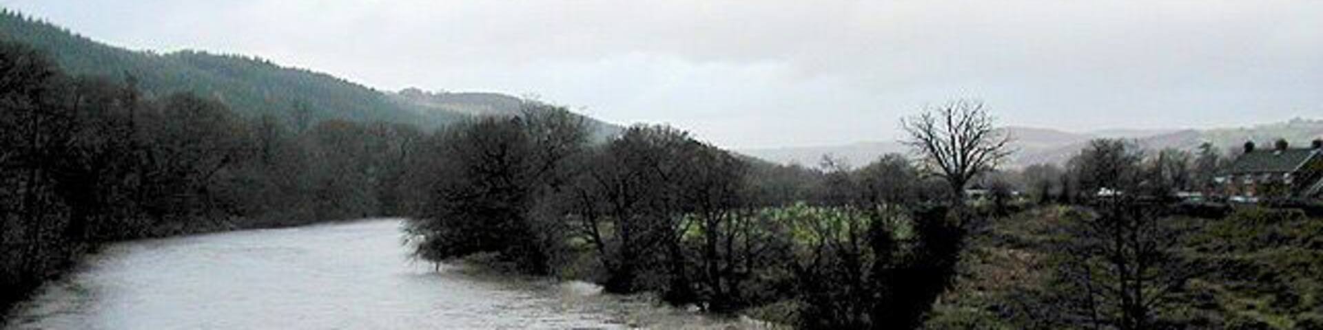 The River Wye in full spate Viewed from the road bridge at Llyswen