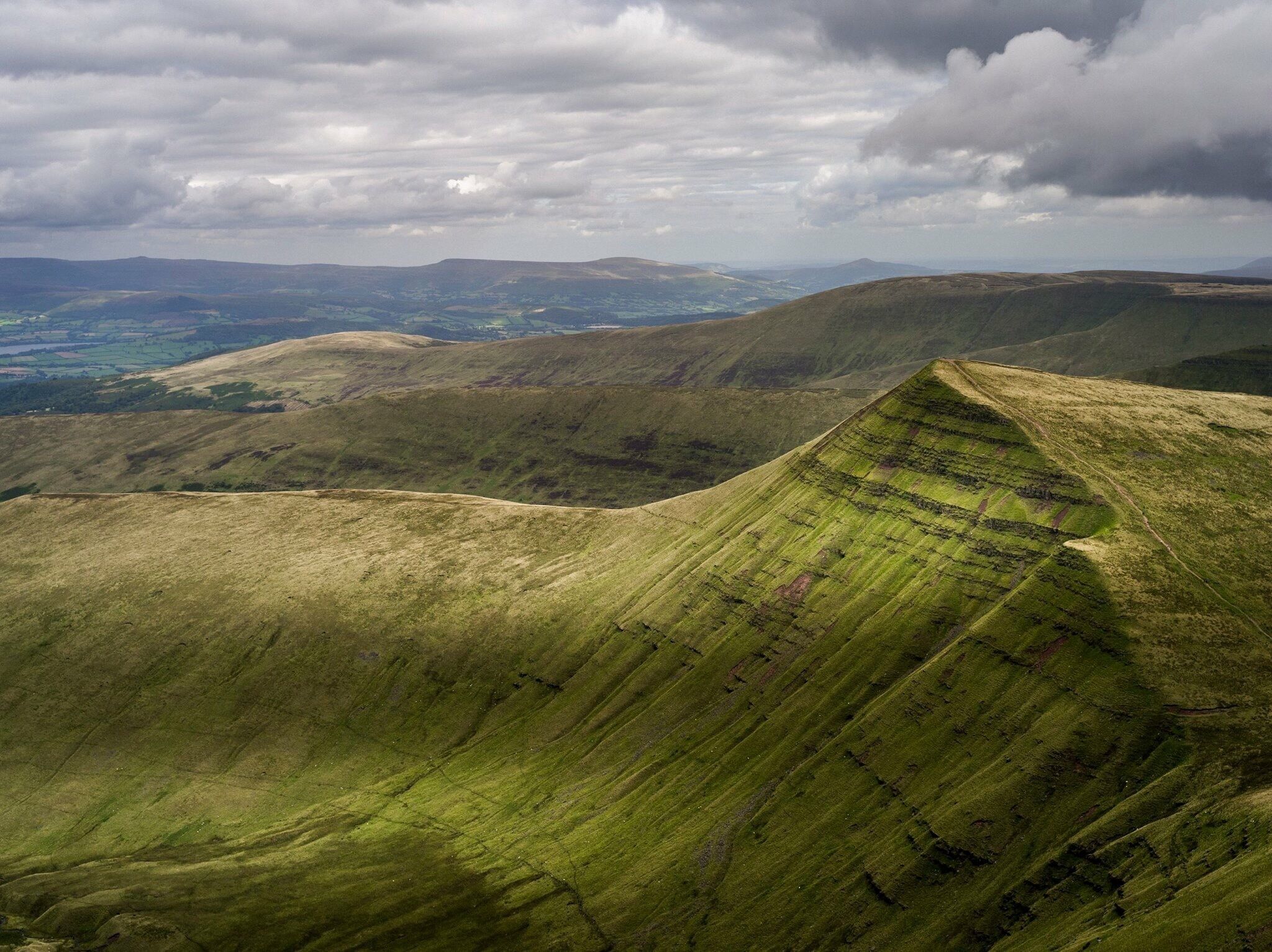 The Brecon Beacons (Welsh: Bannau Brycheiniog) is a mountain range in South Wales. In a narrow sense, the name refers to the range of Old Red Sandstone peaks which lie to the south of Brecon. Sometimes referred to as "the central Beacons" they include South Wales' highest mountain, Pen y Fan. The range forms the central section of the Brecon Beacons National Park 