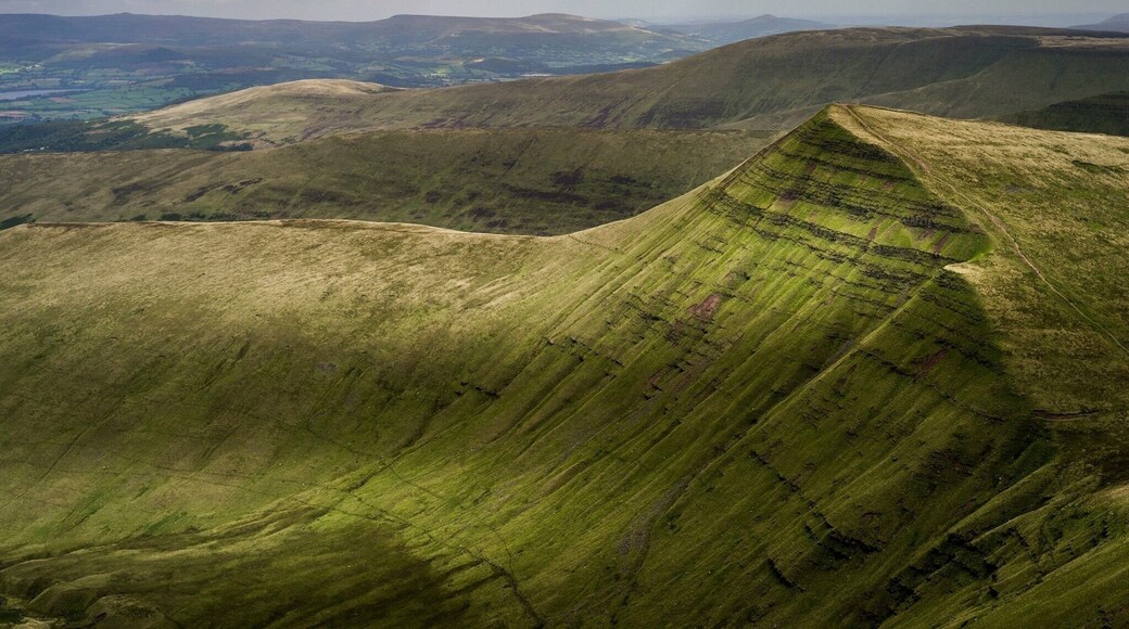 The Brecon Beacons (Welsh: Bannau Brycheiniog) is a mountain range in South Wales. In a narrow sense, the name refers to the range of Old Red Sandstone peaks which lie to the south of Brecon. Sometimes referred to as "the central Beacons" they include South Wales' highest mountain, Pen y Fan. The range forms the central section of the Brecon Beacons National Park