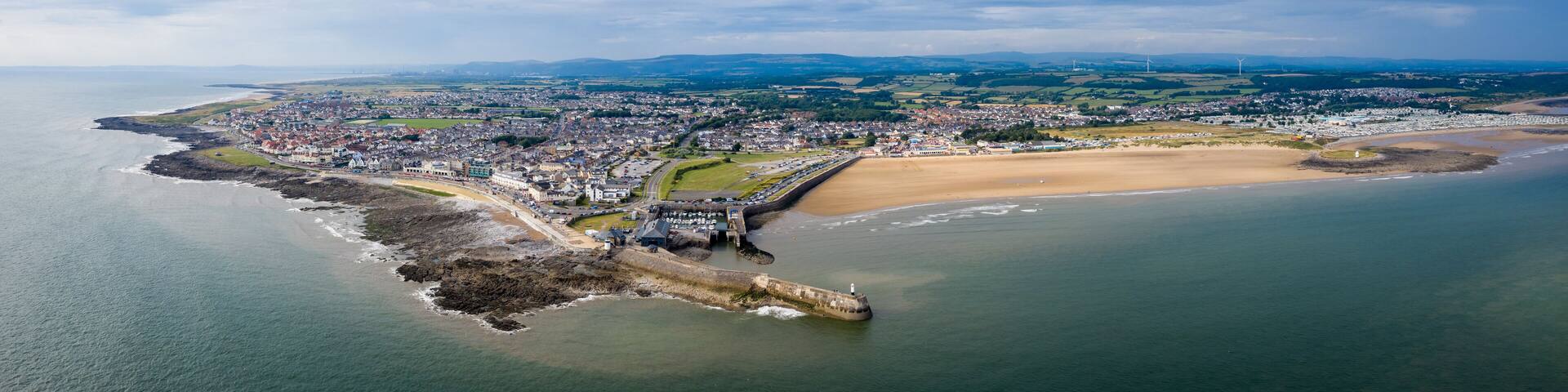 Aerial view of Porthcawl beach harbour and fun fair in South Wales UK