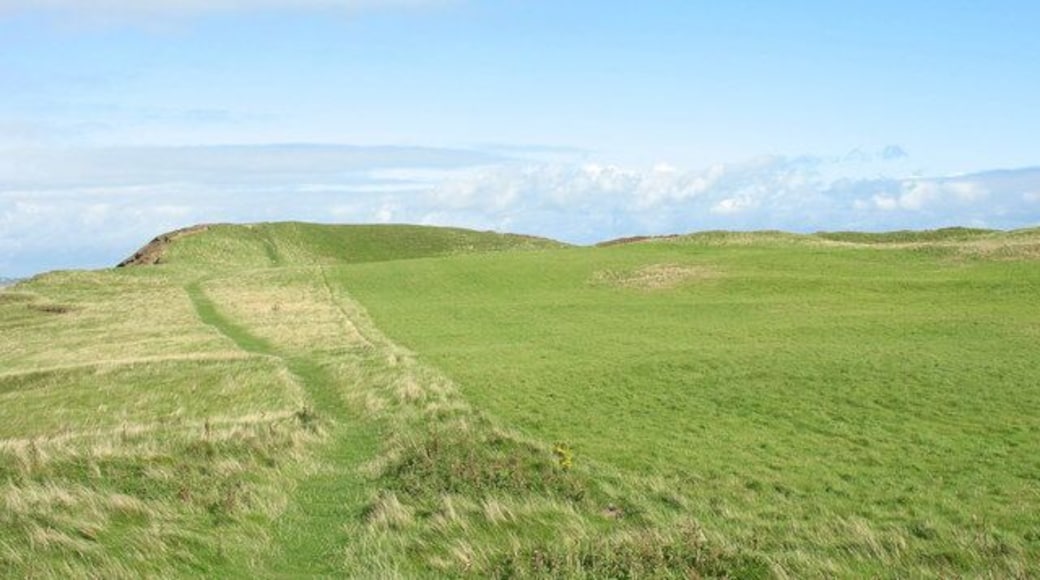 The View North Across Dinas Dinlle Fort This fort which dates from the Iron Age was reoccupied during the Roman period. The western side of the fort has been badly damaged by sea erosion. http://www.gtj.org.uk/en/item1/1234
