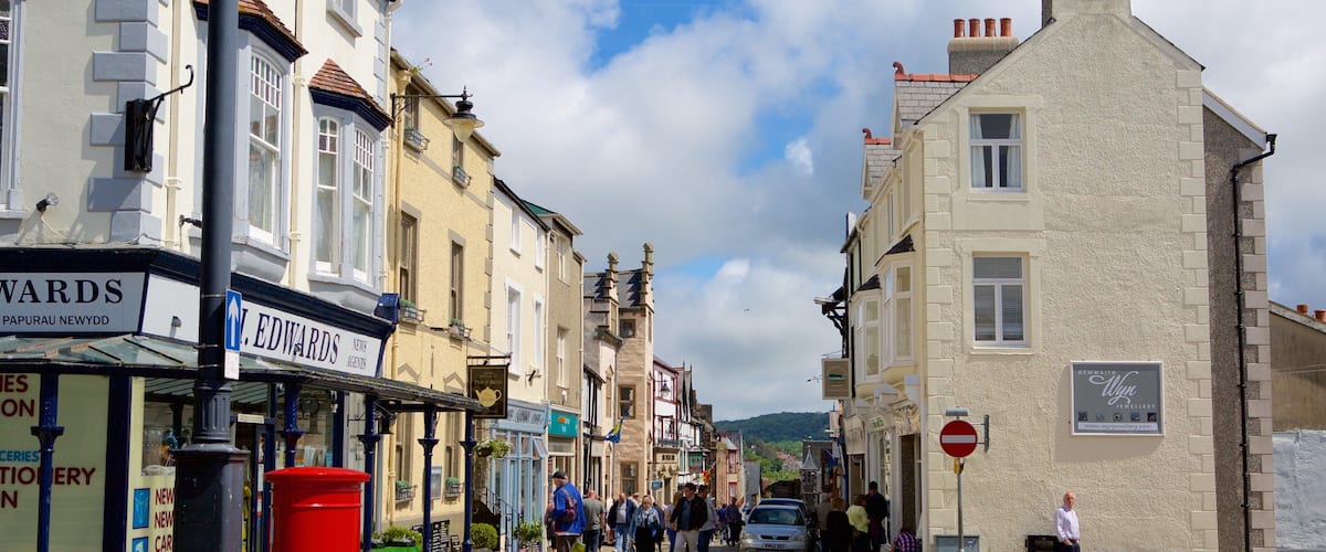 A street with shops, a red post box, and a sign for Church Street.