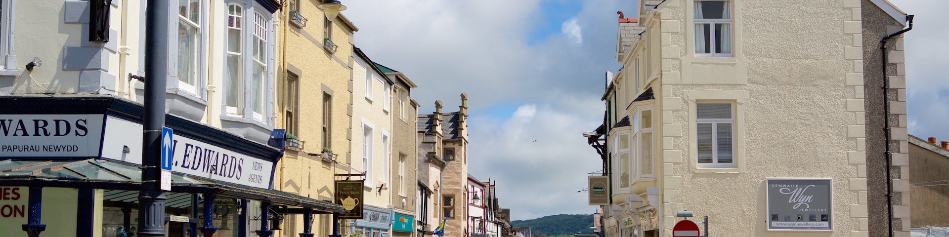 A street with shops, a red post box, and a sign for Church Street.