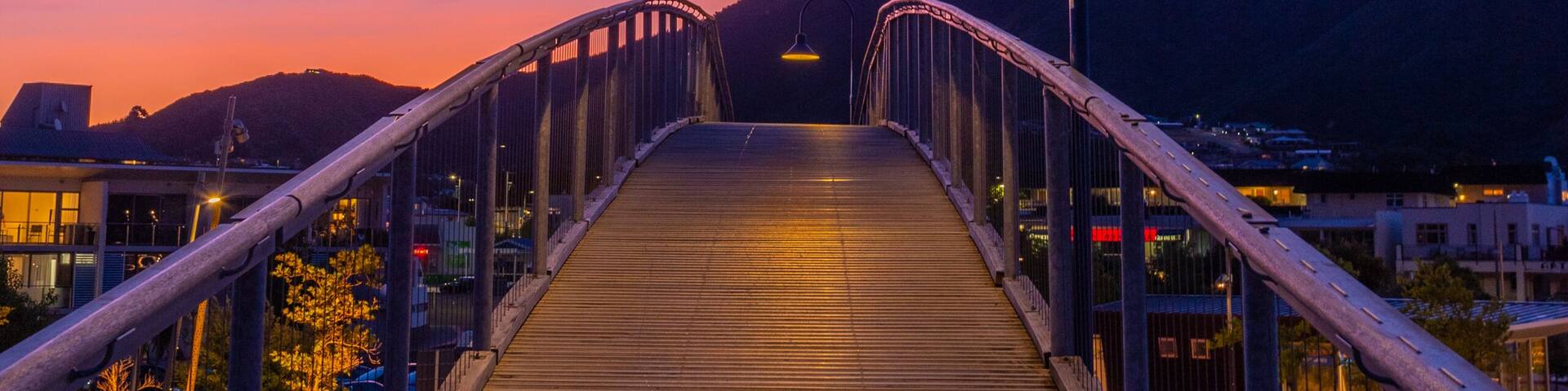 Sunset view over a wooden bridge leading to marina in Picton, New Zealand
