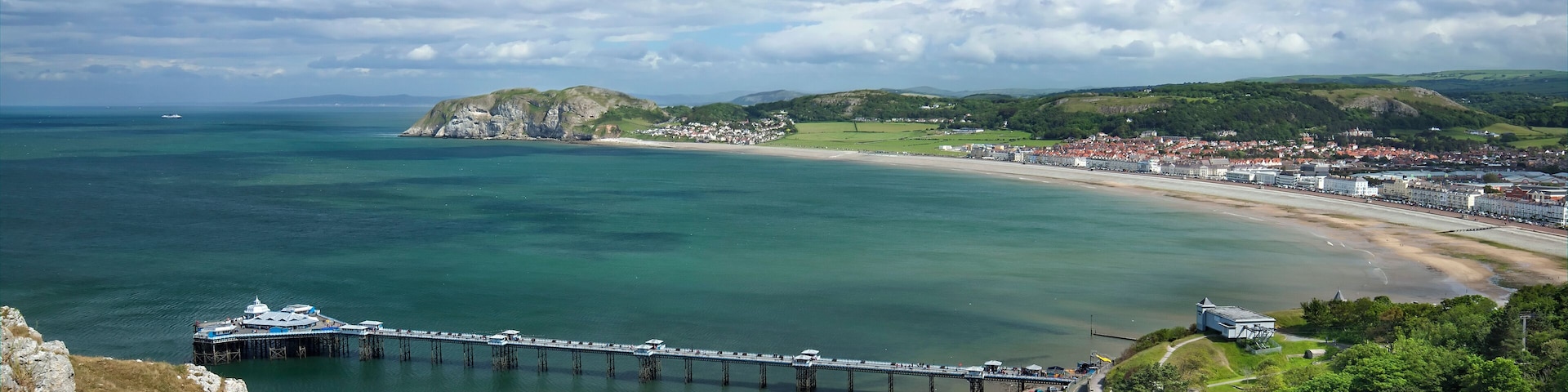 Llandudno, "Queen of the Welsh Resorts", is now the largest seaside resort in Wales, town and community in Conwy County Borough and lies on a flat isthmus of sand between the Welsh mainland and the G