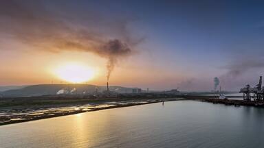 Editorial Port Talbot, UK - September 06, 2023: Sunrise and pollution over Port Talbot Steel Works, UK, also known as Tata Steel, Europe's second-biggest steelmaker.