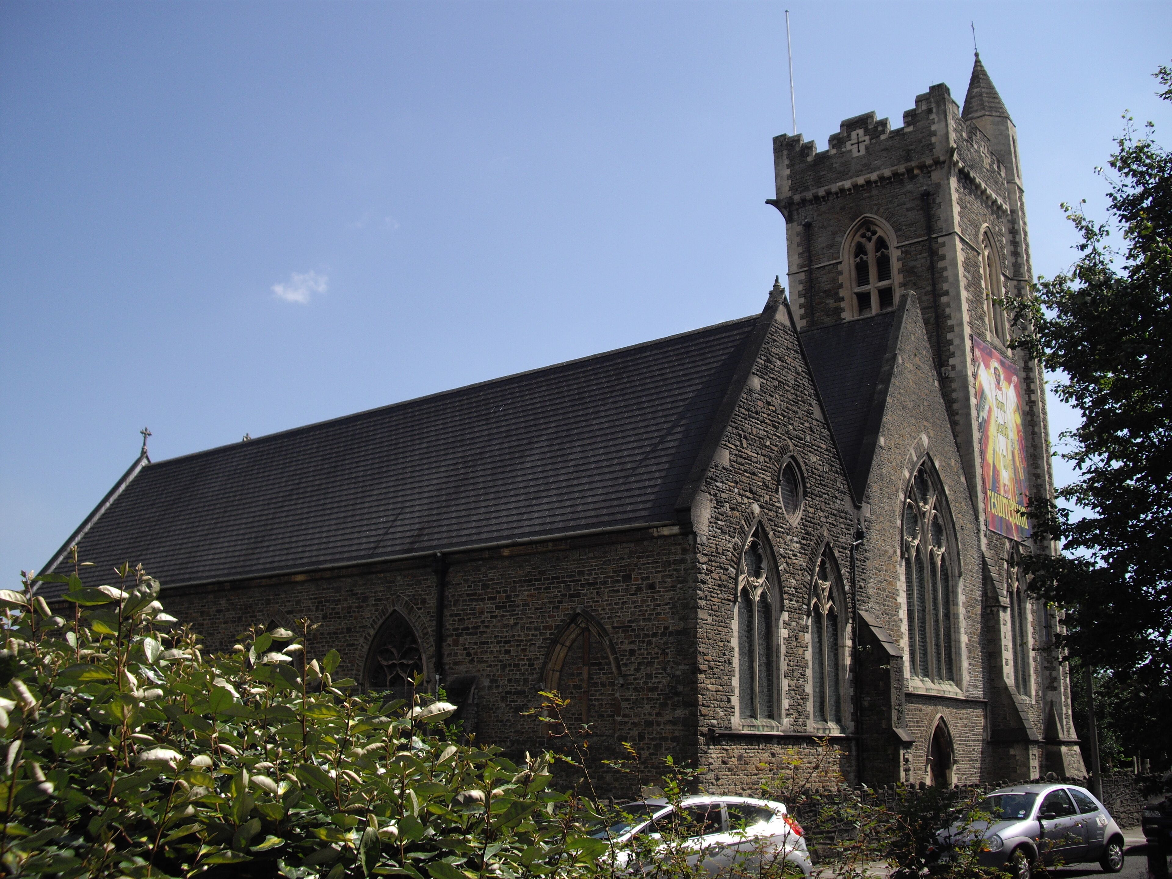 A historic church with a tall tower and arched windows.