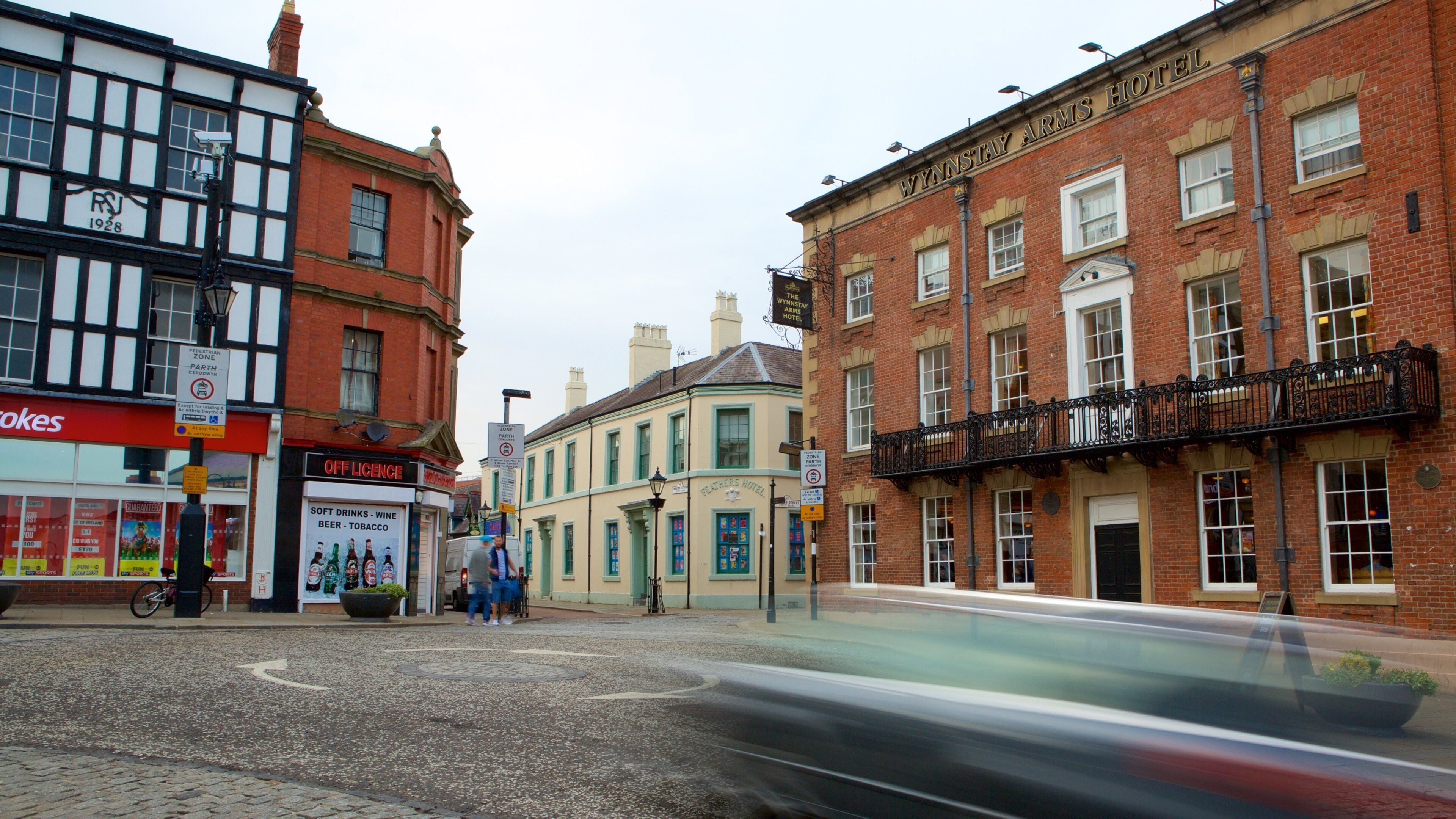 A street with buildings, including a hotel and a store.