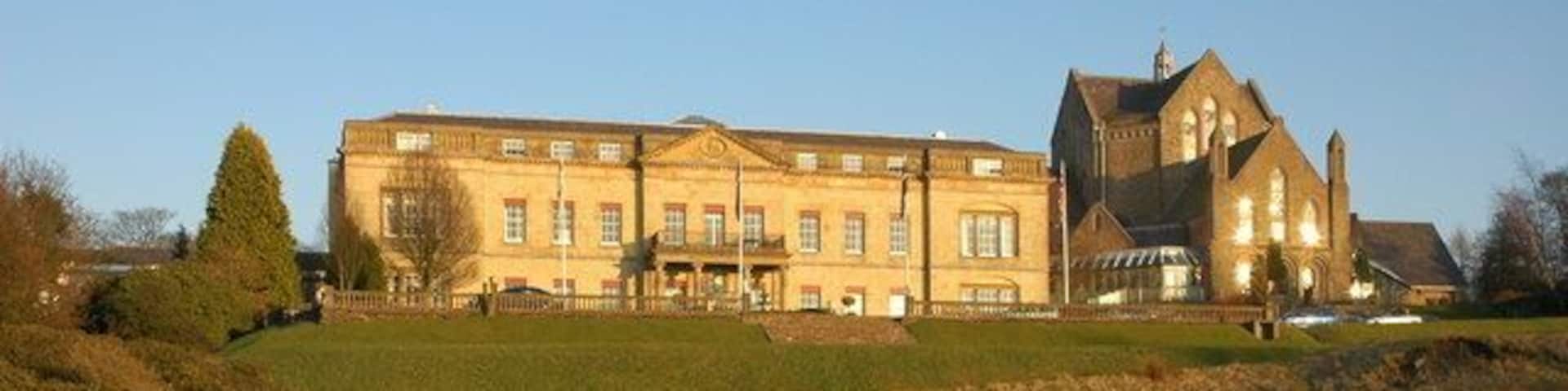 Shrigley Hall Hotel Shrigley Hall Hotel is a former country house which is now owned by the Spanish hotel chain Barcelo, the former church, seen on the right, is now a swimming pool and part of the leisure complex. The hotel grounds amount to a 262 acres golf course. This building has been a hotel since 1989, my old OS map from the 1970s indicates that this building used to be a college.