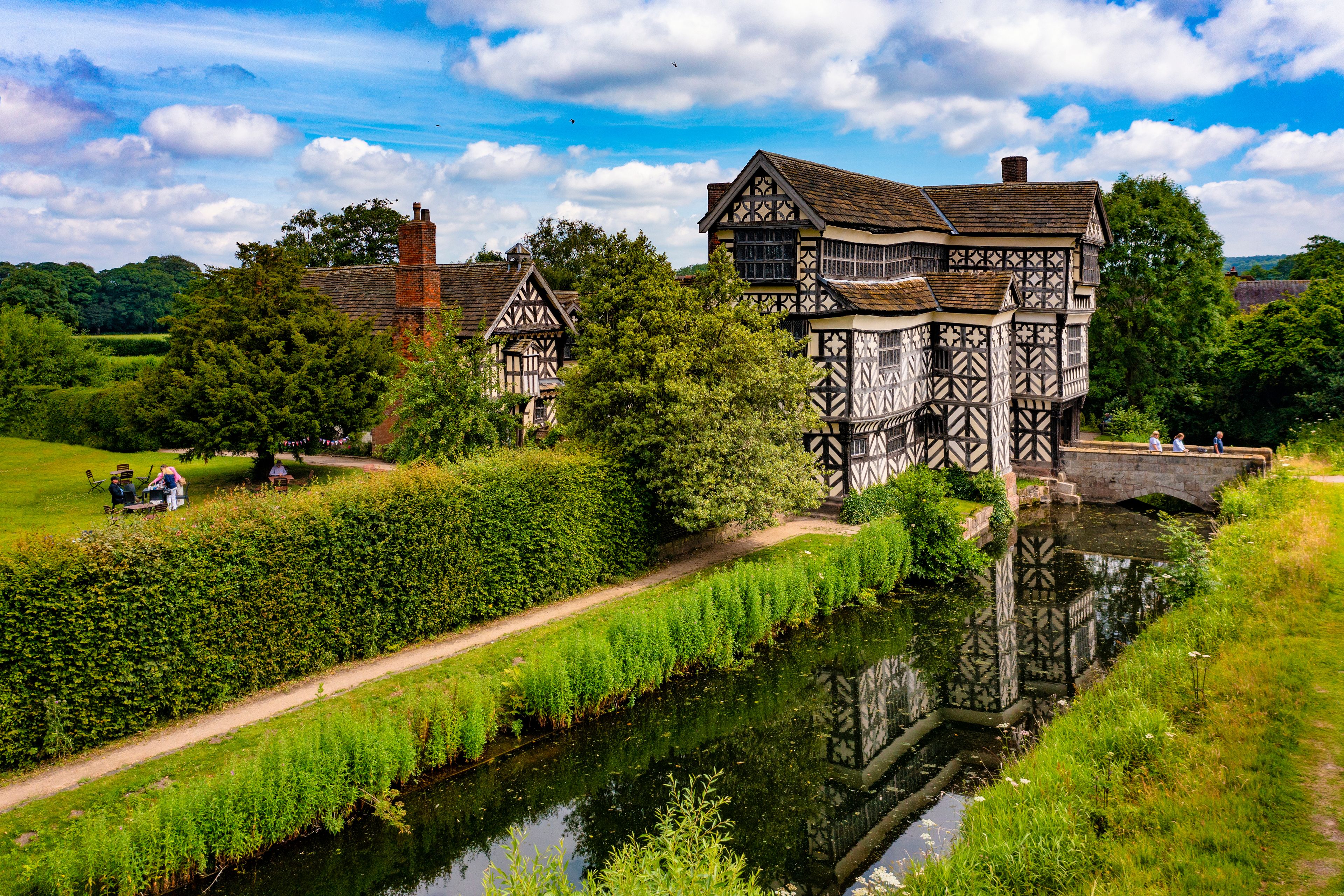 A Tudor-style building with a river in front.
