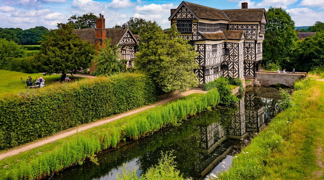 A Tudor-style building with a river in front.