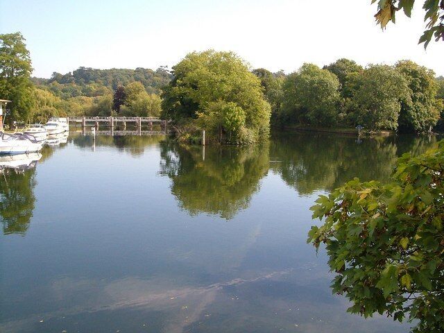 Thames from Cookham Bridge. Looking downstream from the southern end of 1605337. As mentioned in 1605356, the river divides into four channels, and the correct channel for craft is right of centre, clearly marked by a sign on the right of The Lock Cut, so boat users do not have to rely on the old sign lost in the undergrowth on Sashes Island. To the left is a weir on Hedsor Water.