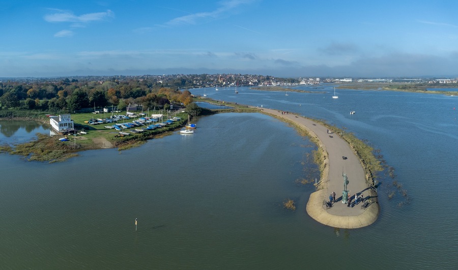Byrhtnoth statue at the esplanade of the tourist town of Maldon in Essex, England. Boats in the marina at blackwater estuary. Drone aerial birds eye view