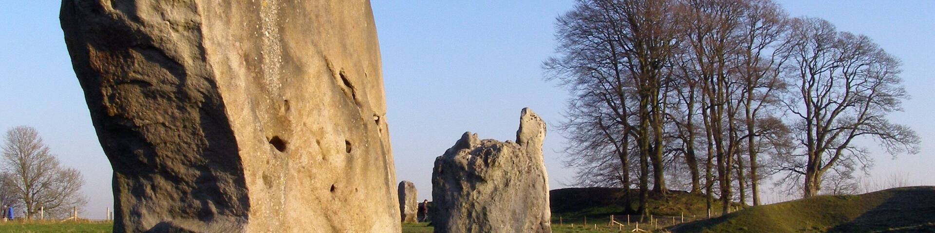 On the left is stone 9 of the south-west quadrant of the Great Circle, also known as the Barber Stone or Barber-Surgeon's Stone. Avebury henge, Wiltshire, U.K.
