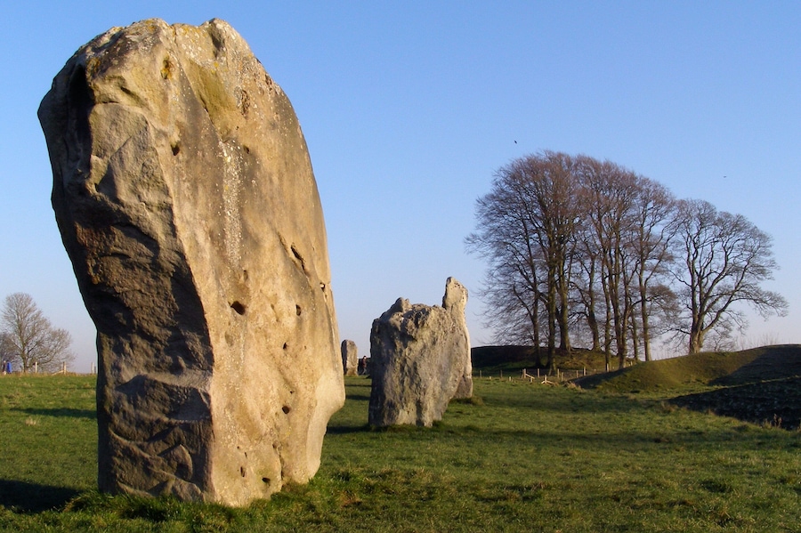 On the left is stone 9 of the south-west quadrant of the Great Circle, also known as the Barber Stone or Barber-Surgeon's Stone. Avebury henge, Wiltshire, U.K.