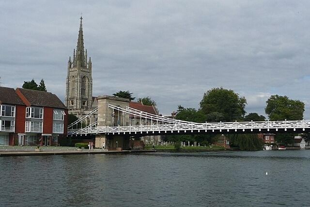 A bridge over a river, a church, and residential buildings.