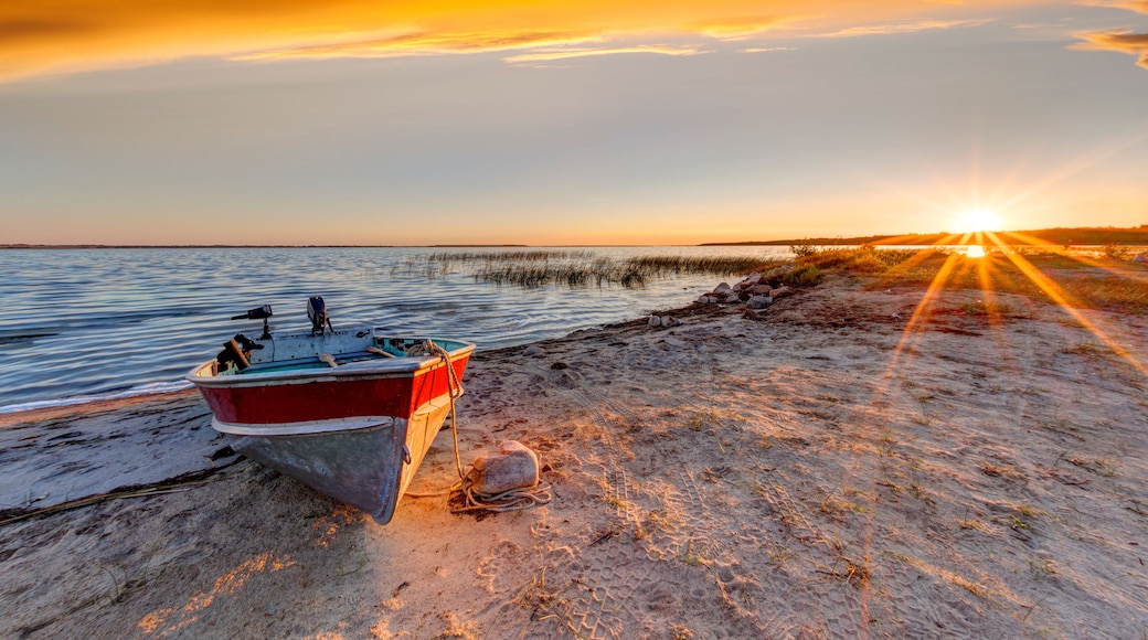 Boat on Beach at Dramatic Sunrise Over Buffalo Lake, Alberta