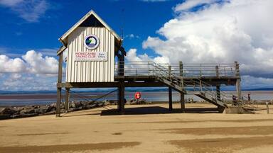 A beach hut with a sign for Morecambe Sailing Club.