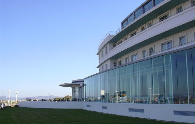 A modern building with large glass windows and a flat roof.
