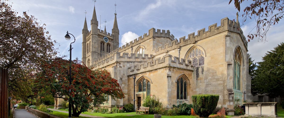 A historic church with twin spires and a large arched window.